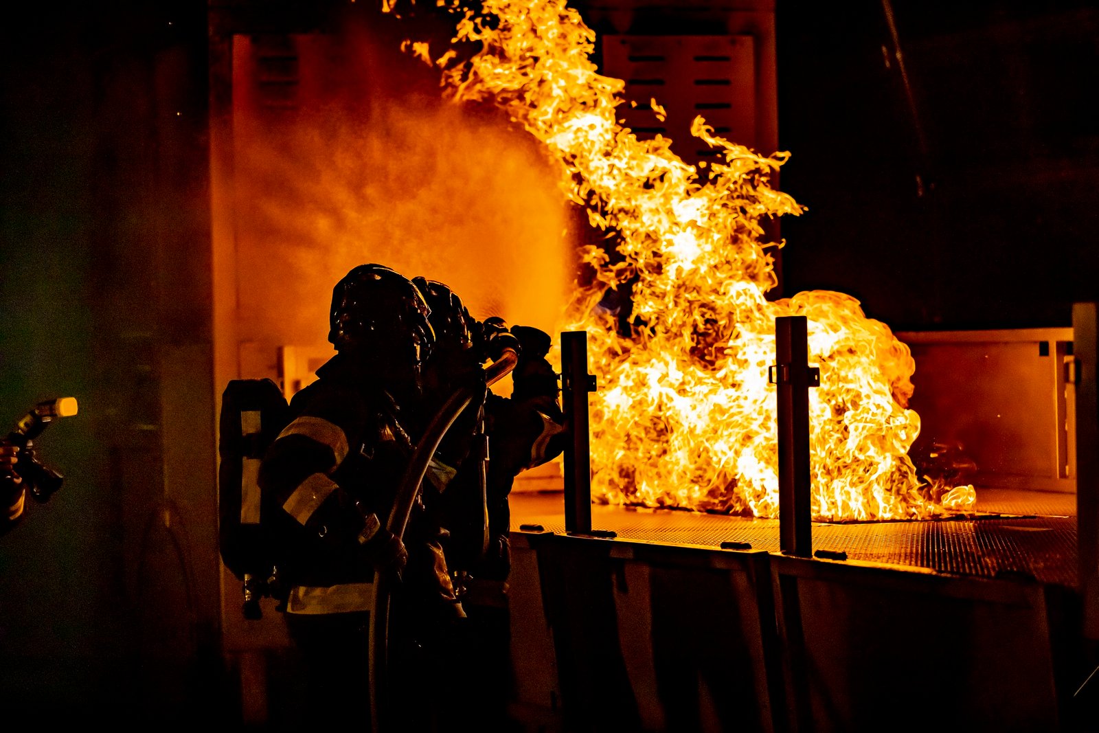 Firefighters controlling house fire