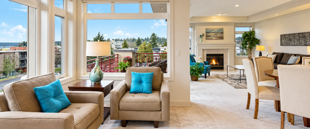 Illustrative bright open-plan living room with large windows, lounge seating, and dining area